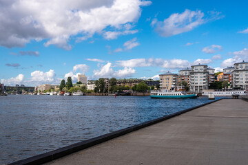 Obraz premium Large pier jetty on the city embankment close up. Panoramic view of the new modern district of Stockholm 