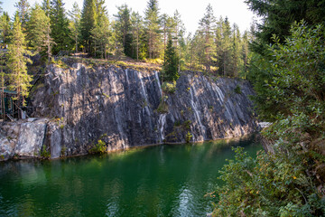 mountain lake with clear green water in granite and marble rocks in a natural monument