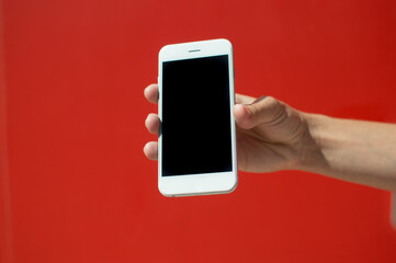 Female holding touch screen mobile phone, closeup.