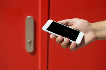 Closeup on mobile smart phone near door.
