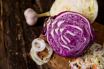 Fototapeta premium red cabbage, green cabbage, onions, garlic, grated carrots. Vegetable ingredients on the table, place for text, copy space. Background image