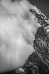 Close-up of Matterhorn mountain with clouds hanging at mountain ridge (black and white)