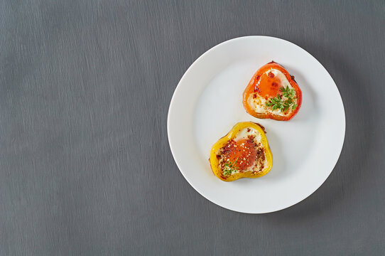 Served Dish Of Bell Pepper Rings Stuffed Of Fried Eggs In Restaurant On Concrete Table. Tasty Breakfast