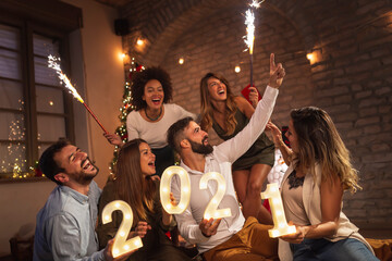 Fototapeta na wymiar Friends having fun at New Year's midnight countdown