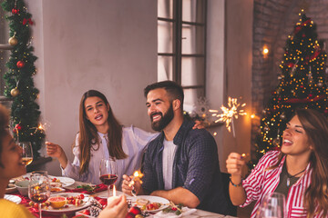 Friends having fun during Christmas dinner