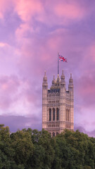 Houses of parliament at sunset with union jack flag London england uk 
