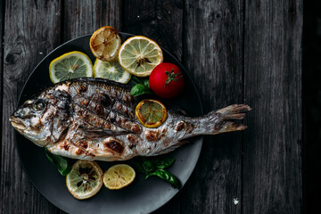 Grilled Dorado fish with lemon and tomato