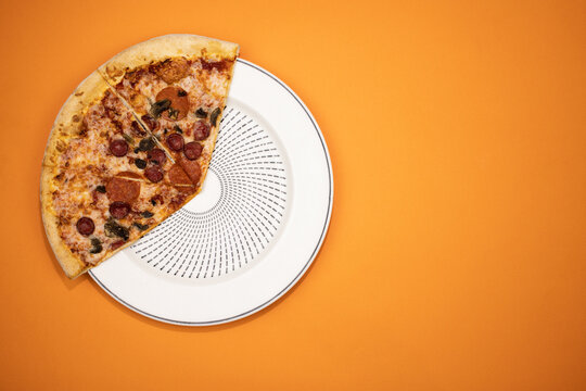 A Slice Of Pizza On A White Plate.