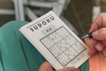 Old woman exercicing her brain for memory loss.