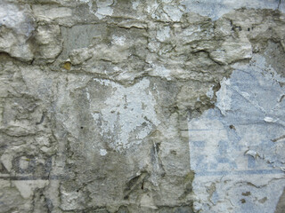 dirty rough concrete surface with scratches and scraps of ads, brutal and harsh background