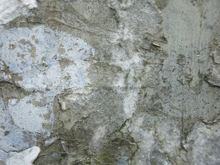 dirty rough concrete surface with scratches and scraps of ads, brutal and harsh background
