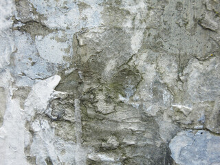 dirty rough concrete surface with scratches and scraps of ads, brutal and harsh background