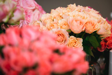 Bunch of orange roses surrounded by pink roses.