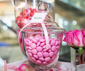 Pink candy in a glass vase.