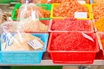 Dry shrimps of various sizes in the basket for sale in market for customer.