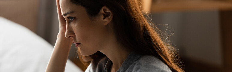 horizontal image of upset brunette woman at home