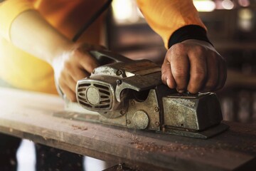 Carpenter is using tools to clear the wood, straighten the wood.