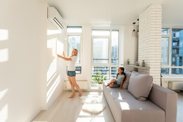 mother and daughter hold photo canvas at home