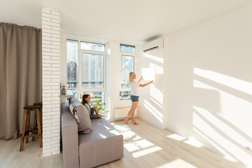 mother and daughter hold photo canvas at home