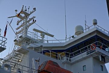 Oslo, Norway - Aug. 29th 2020: THe bridge with a lifeboat, antennas and radar of a large cargo ship.