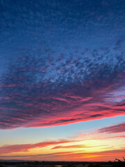 Dramatic colorful pink cloud formation at sunset