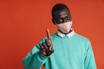 Serious afro american man wearing medical mask