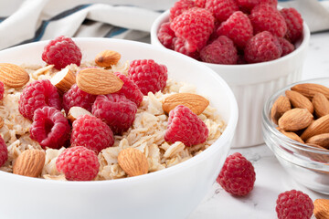 bowl of oatmeal with raspberries and almonds