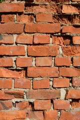 Old wall of crumbling, crumbling bricks. Close up