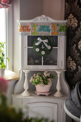 Baby girl 1 year old eating birthday cake in room. Birthday party. Childhood