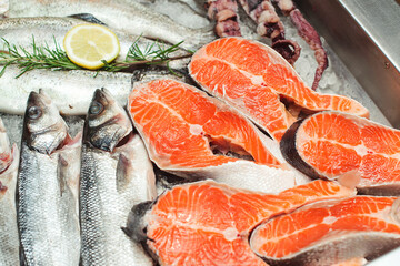 Fresh fish and other seafood on showcase. Top view. Fish food at shop, close up. Raw fish ready for sale in the supermarket.