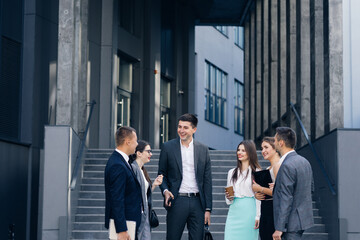 Obraz premium Businessman in suit talking to business people colleagues or partner. Male leader discussing work at team meeting or group negotiations having conversation.