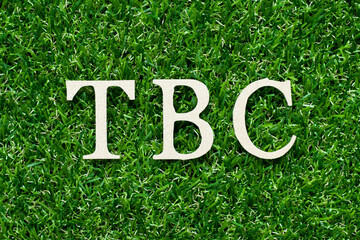 Wood alphabet letter in word TBC (Abbreviation of to be confirmed or continued) on green grass...