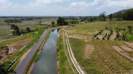 Fototapeta na wymiar rice field irrigation channel in Nanggulan Kulon Progo