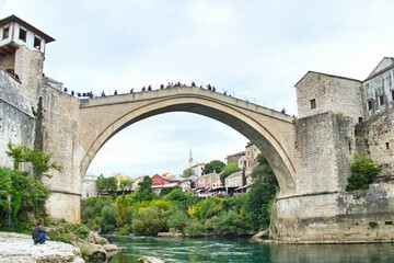 Fototapeta na wymiar The historic town of Mostar, spanning a deep valley of the Neretva River, is famous for Old Bridge, Stari Most. The Ottoman architecture is protected by UNESCO