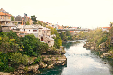 The historic town of Mostar, spanning a deep valley of the Neretva River, is famous for Old Bridge,...