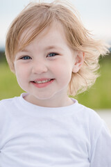 Joyful child girl in white tshirt on summer day.