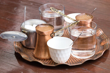 Delicious Bosnian coffee is served with rahat lokum dessert in the traditional turkish coffee pot