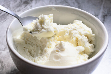 Spoon of vanilla ice cream. Seletive focus.