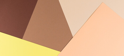 Color papers geometry composition background with yellow, beige and brown tones.