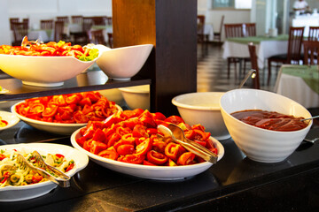 Catering food, salad in a white plate, sliced tomatoes
