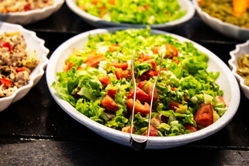 Catering food, salad in a white plate, buffet