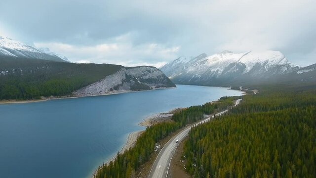 Aerial footage of the forest road running near Spray Lakes Reservoir in Alberta, Canada
