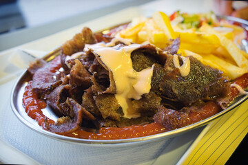 Traditional Bosnian street food - doner kebab with french fries and vegetable salad