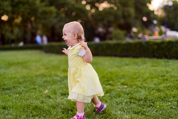 Smiling girl on the meadow looking right at camera. authentic image.