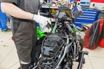 Fototapeta na wymiar The master performs maintenance on the motorcycle.