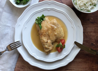 Chicken cutlet with sauce and rice. Delicious Austrian Naturschnitzel.