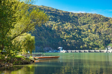 An old fishing boat on the tranquil surface of Drina river on the border between Serbia and Bosnia and Herzegovina