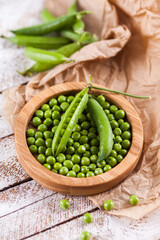 Fresh green peas in bowl  on table close up