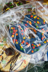 Fototapeta premium Large donut in blue-blue glaze with multi-colored sprinkles