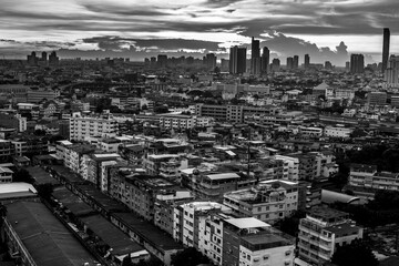 The high angle background of the city view with the secret light of the evening, blurring of night lights, showing the distribution of condominiums, dense homes in the capital community